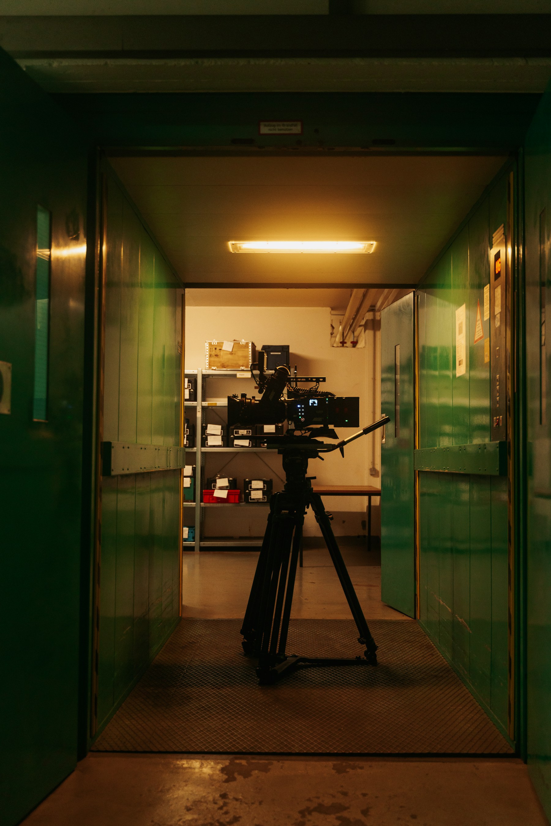 Cinema camera on a tripod set up in a room