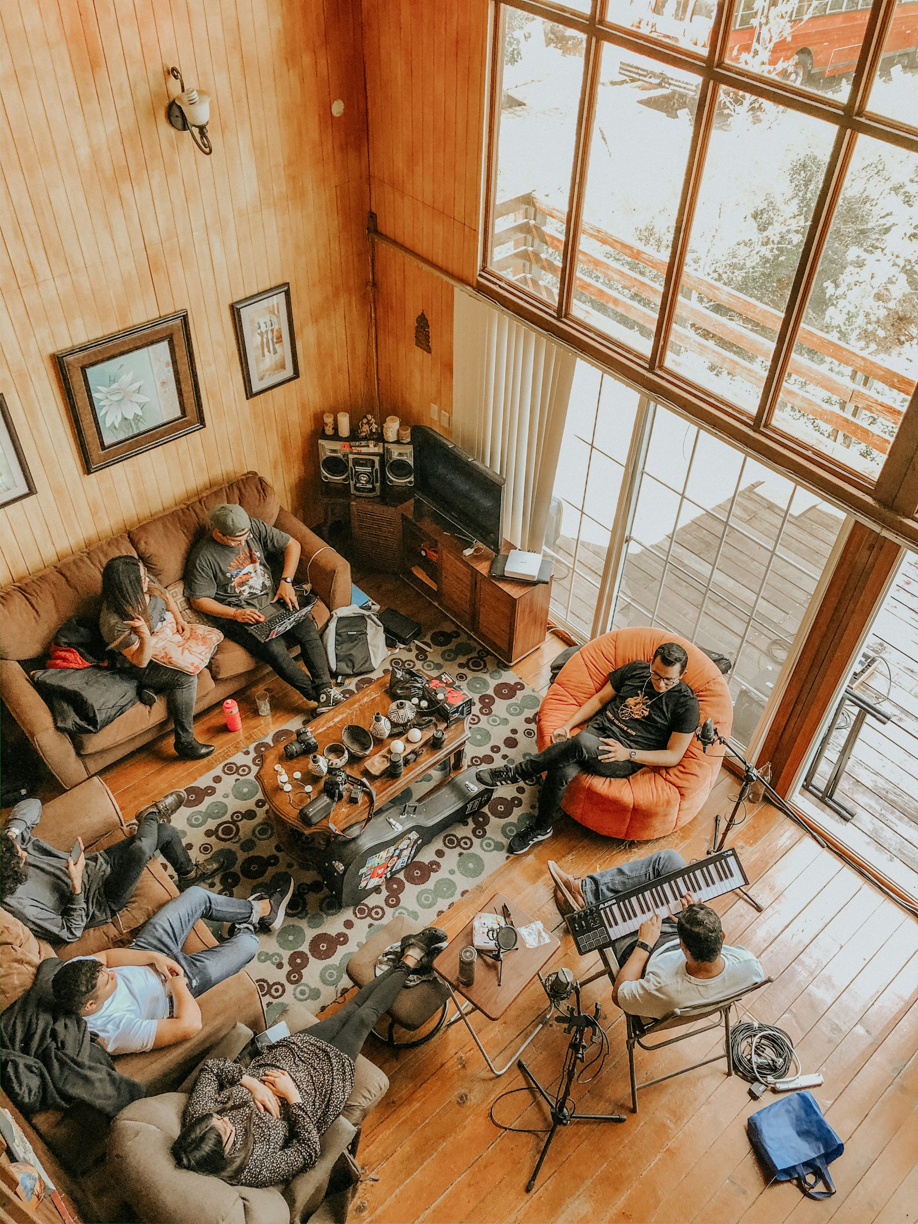 People sitting together on the floor inside a room in conversation
