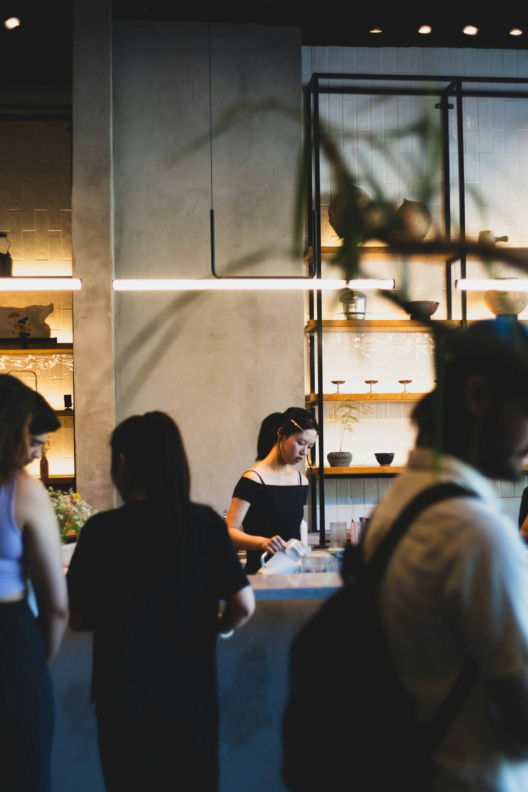 People gathered at a counter inside a modern building